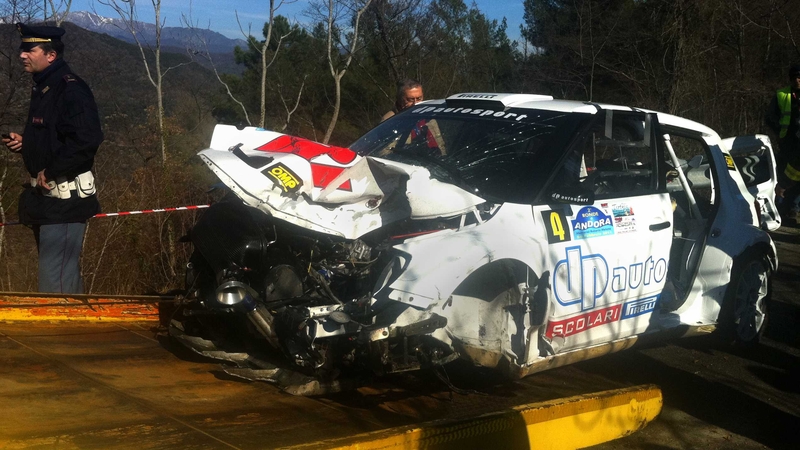 The wreckage of Robert Kubica's Skoda Fabia is loaded onto a tow truck in Andora