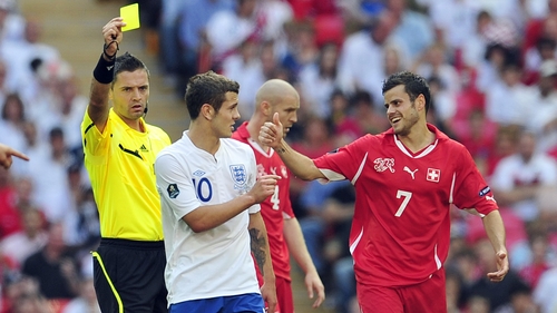 Wilshere receives a yellow during his last international appearance for England