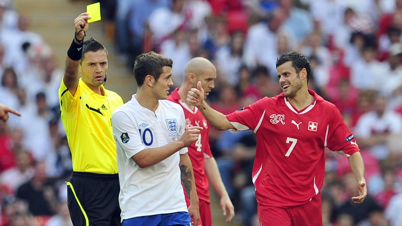 Wilshere receives a yellow during his last international appearance for England