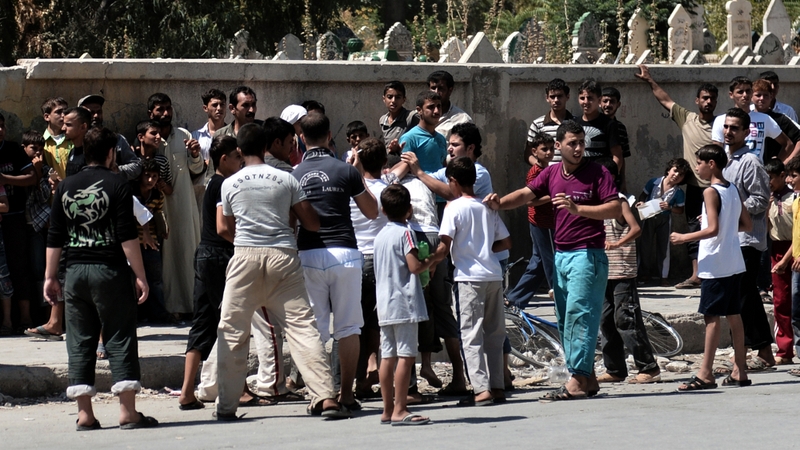 Syrian civilians line up for bread in the northern city of Aleppo