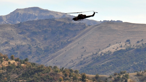 A Turkish military helicopter flies over a mountain in Hakkari province