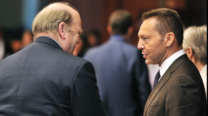 Michael Noonan speaking to Greece's finance minister Yannis Stournaras at a meeting in July