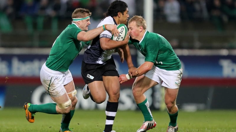 Ravai Fatiaki tackled by Jamie Heaslip and Luke Marshall during Ireland's 53-0 victory