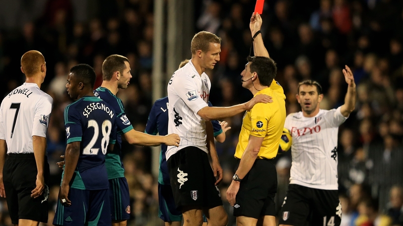 Brede Hangeland of Fulham is shown a straight red card by referee Andre Marriner