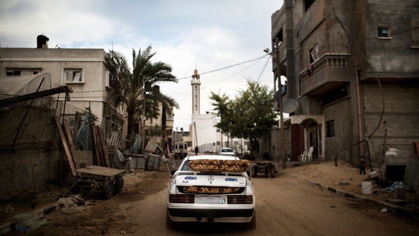 A Palestinian family returns home after the ceasefire was announced