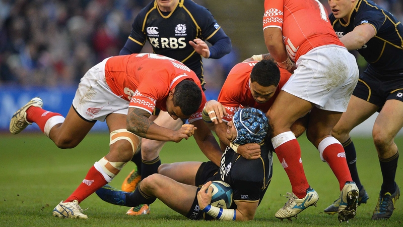Scotland's Sean Lamont is tackled by Halani Aulika, Sione Piukala and Nili Latu of Tonga