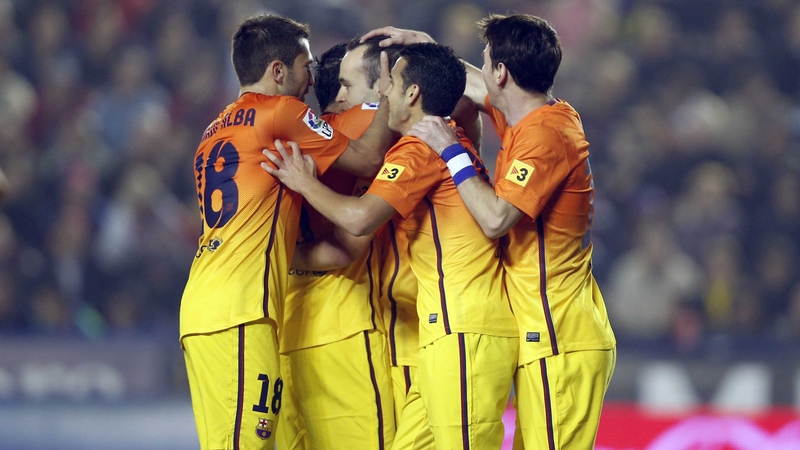 Andres Iniesta is mobbed by his Barca team-mates after scoring at the Ciutat de Valencia Stadium