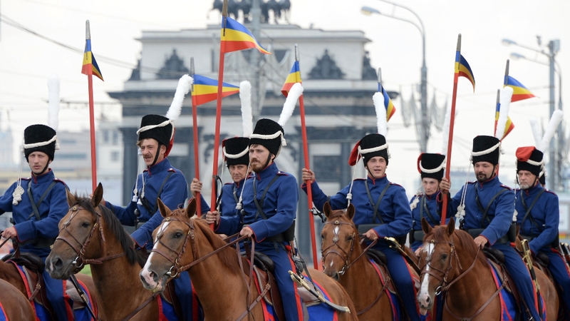 Russian cossacks, wearing historic outfits, ride horses during a march in Moscow in August