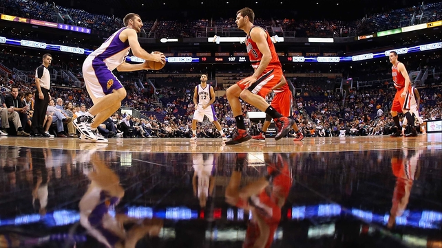 Luke Zeller of the Phoenix Suns looks to shoot guarded by Elliot Williams of the Portland Trail Blazers during the NBA game at US Airways Center