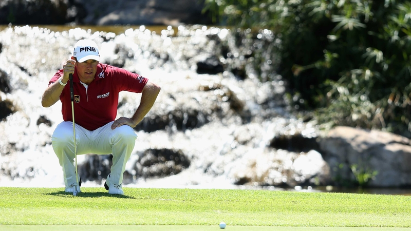 Defending champion Lee Westwood lines up a putt on the ninth