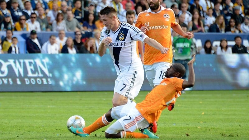 Robbie Keane takes on Dynamo's Colin Clark