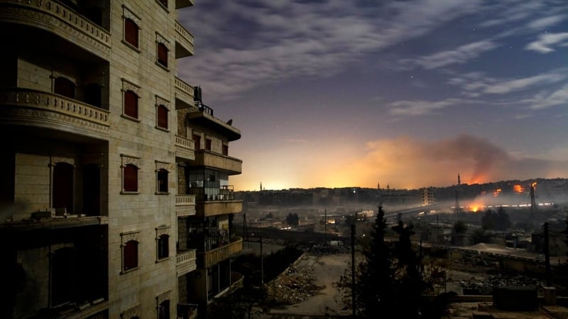 Smoke rises in the northern city of Aleppo on 1 December, as fighting continues through the night