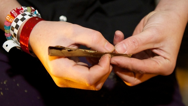 A Tacoma resident rolls a joint shortly after a law legalising the recreational use of marijuana