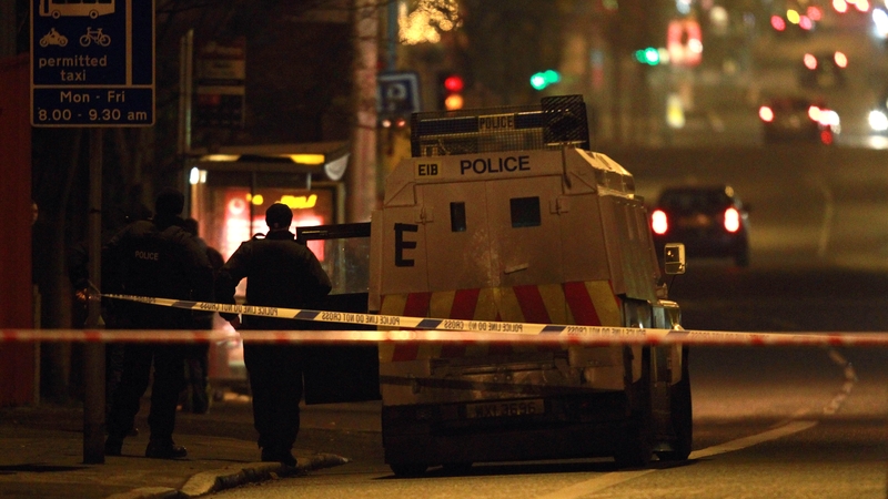 Police patrol the area in Belfast where a police officer was attacked with a petrol bomb