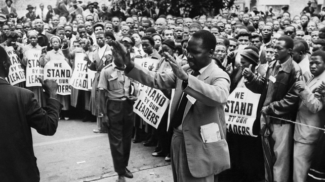 ANC supporters pray in front of the courthouse of Johannesburg in December 1956, to support 152 anti-apartheid militants, including Nelson Mandela, during their trial