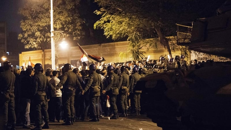 Egyptian soldiers cordon off an area in Cairo as opposition supporters hold a rally
