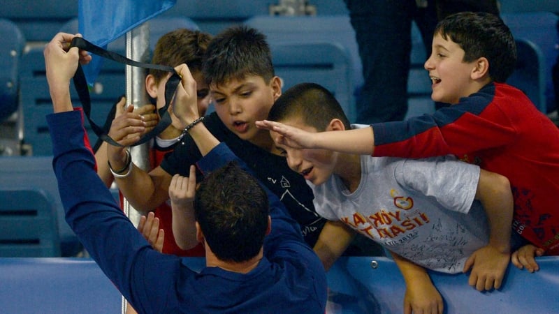 Ryan Lochte of USA gives his medal to a Turkish child, Arda Cakmak (second left), after the men's 200m individual medley