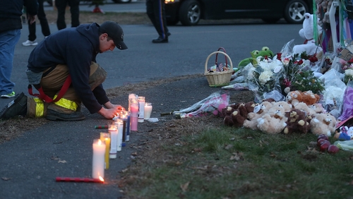 Mourners lit candles outside Sandy Hook Elementary School in Newtown, Connecticut