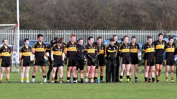 The Dr Crokes team observe a minutes' silence for Páidí Ó Sé at today's game