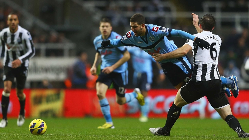 Adel Taarabt of Queens Park Rangers is tackled by Mike Williamson of Newcastle