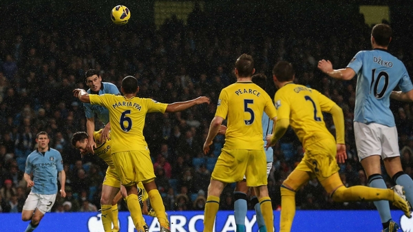 Gareth Barry rising to score Manchester City's injury-time winner