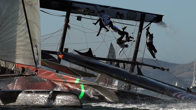 The Oracle Team USA skippered by James Spithill flips over during a fleet race in the America's Cup World Series