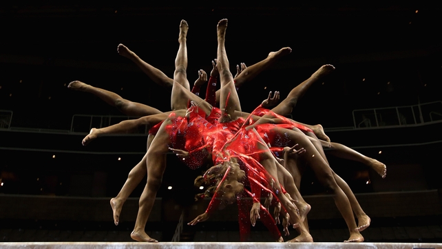 Kennedy Baker practices on the beam before the start of competition at the 2012 US Olympic Gymnastics Team Trials