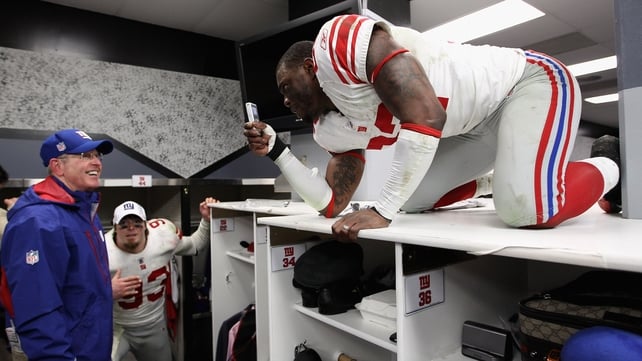 Derrick Martin of the New York Giants makes a video of head coach Tom Coughlin as they celebrate winning the NFC Championship