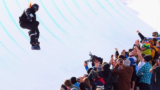 A snow boarder soars above the spectators during the Winter X Games