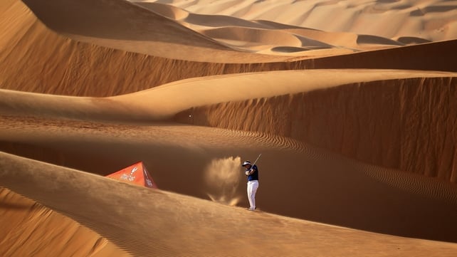 Luke Donald plays a shot amid 250ft sand dunes at the Abu Dhabi Golf Championship
