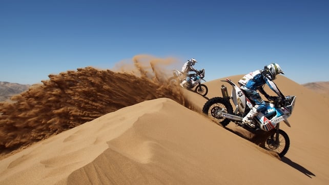 Michael Pisano of France rides over a sand dune during stage seven of the 2012 Dakar Rally