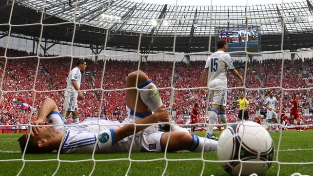 Kostas Katsouranis of Greece lies on the turf after the Czech Republic score