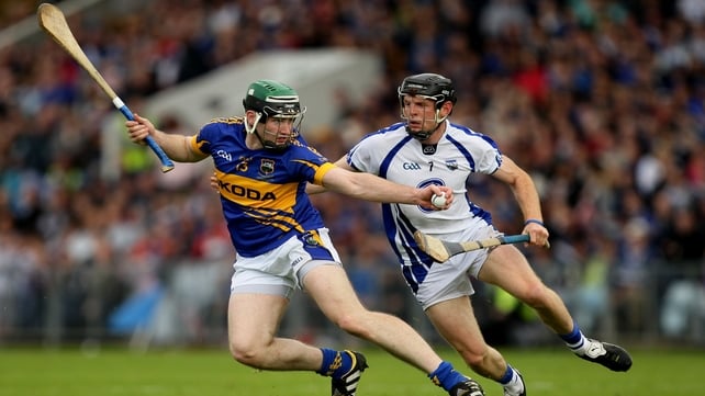 Tipperary's Brian O'Meara takes the ball past Kevin Moran of Waterford in the Munster final
