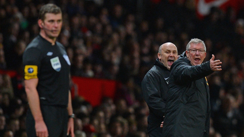 Alex Ferguson and his assistant Mike Phelan gesture to assistant referee Jake Collin during Man United's clash with Newcastle