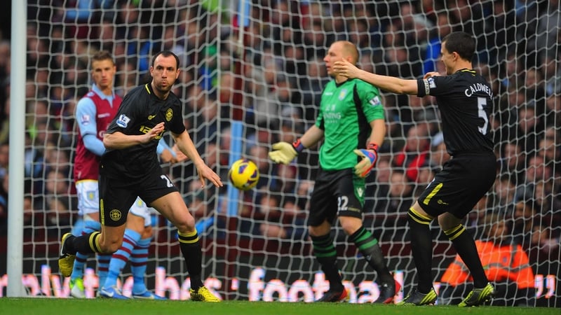 Ivan Ramis (L) wheels away after giving Wigan the lead