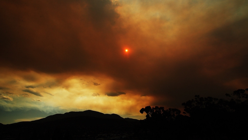 Clouds from a nearby bushfire are seen over Mount Wellington is Tasmania