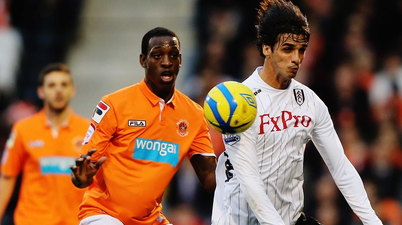 Isaiah Osbourne (l) of Blackpool challenges Bryan Ruiz of Fulham