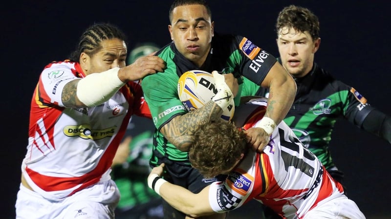 Dragons' Andy Tuilagi and Hallam Amos tackle Fetu'u Vainikolo of Connacht