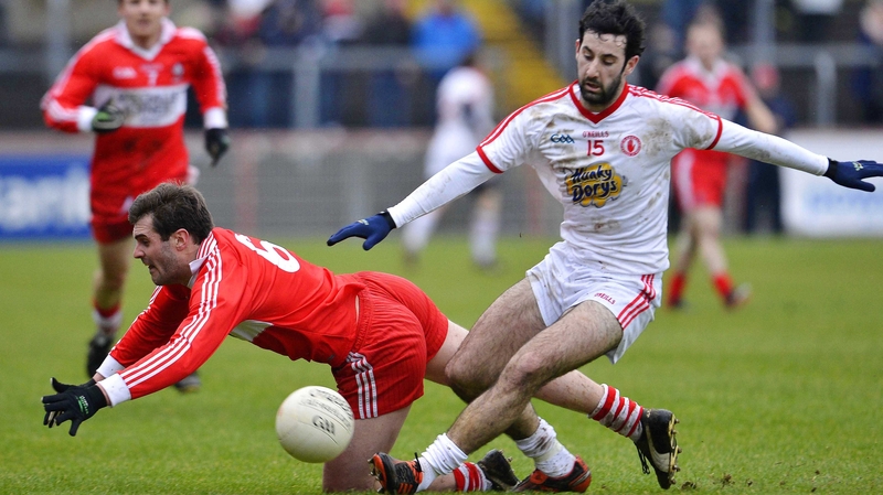 Tyrone's Jonathan Lafferty and Mark Lynch of Derry tussle for possession