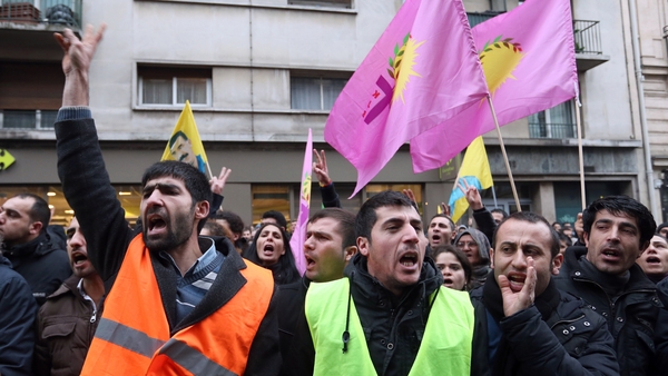 Hundreds of people, including Kurds, gathered on the street near the scene of the murders