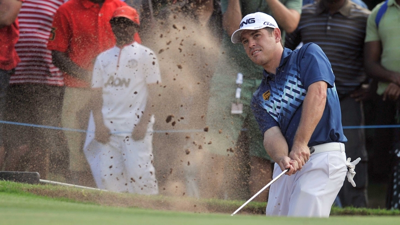 Louis Oosthuizen takes a shot out of the bunker on the 16th hole