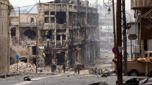 Syrian government troops take position in a heavily damaged area in the old city of Aleppo in northern Syria