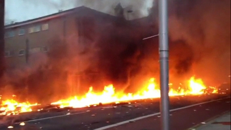 Burning wreckage and aviation fuel covered the road
