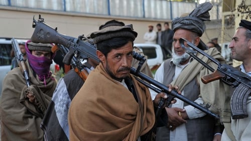 Former Taliban fighters carry their weapons prior to handing them over as they join a government peace and reconciliation process at a ceremony in Jalalabad last week