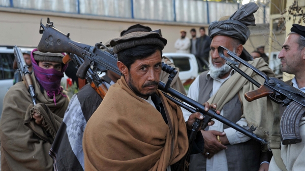Former Taliban fighters carry their weapons prior to handing them over as they join a government peace and reconciliation process at a ceremony in Jalalabad last week