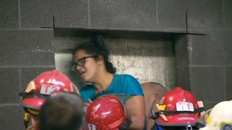 The woman was freed after four hours stuck between the walls