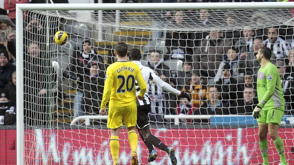 Reading midfielder Danny Guthrie (l) watches on as Yohan Cabaye (not pictured) scores