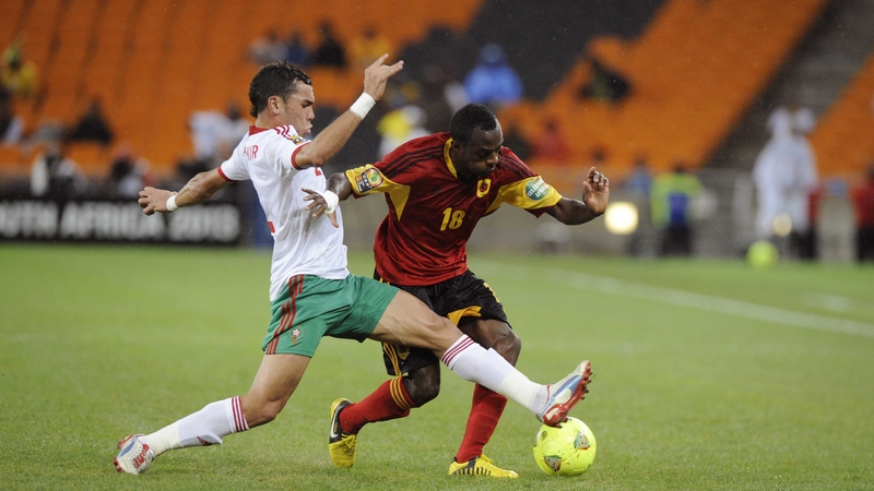 Angola's Geraldo is challenged by lunging Morocco star Nordin Amrabat