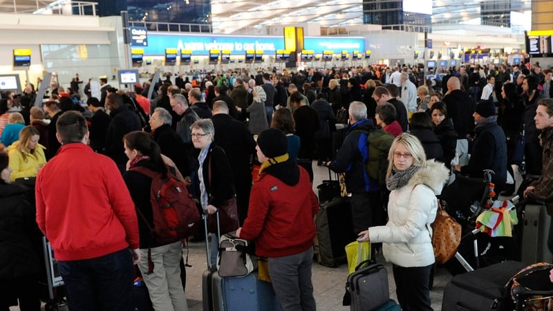 Passengers queue at for the check-in desks at Heathrow airport after hundreds of flights were cancelled