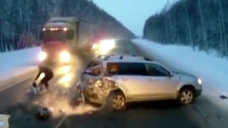 The girl's father rushes to snatch her from the path of an oncoming lorry
